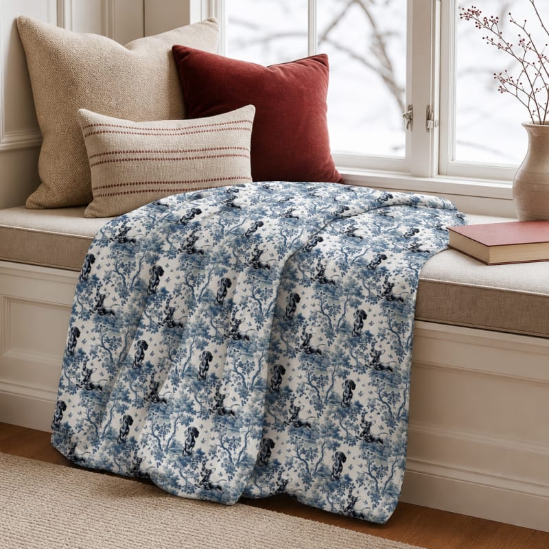 Dachshund blue toile blanket on a window seat