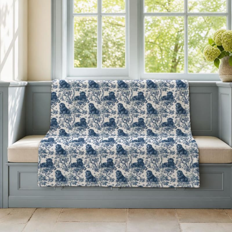 Newfoundland breed toile blanket on a window seat