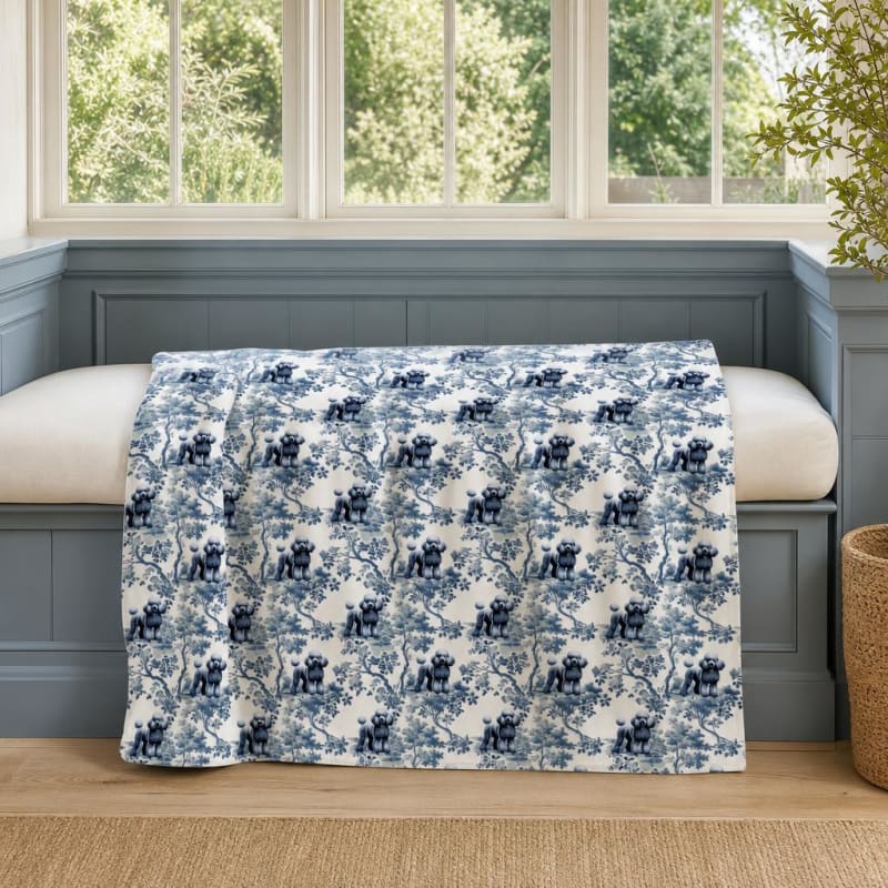 Poodle breed toile blanket on a window seat