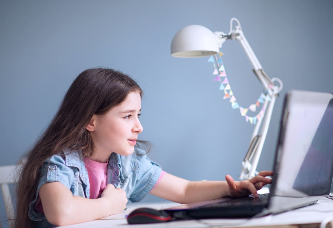Primary school student having fun in an online classroom