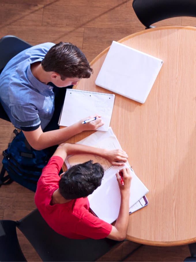 High school tutors sitting around a table together