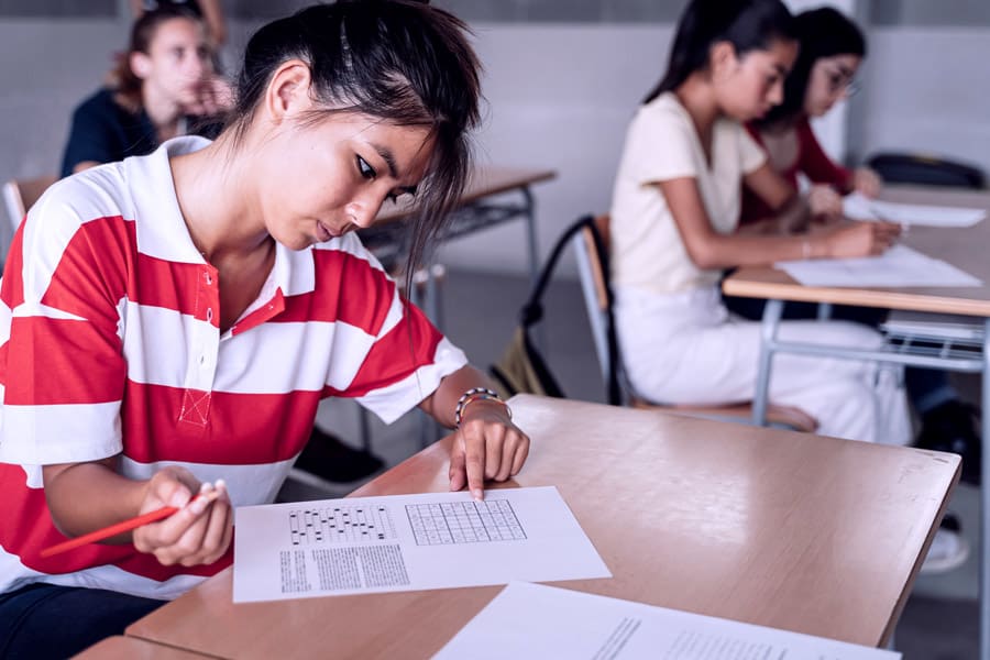 student writing answers during the entrance exam