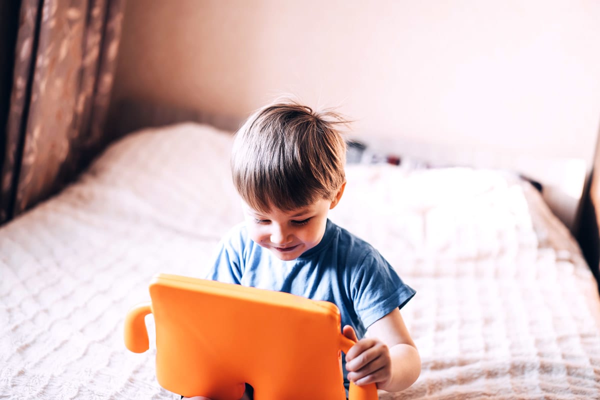 young boy having fun with different online tutoring programs