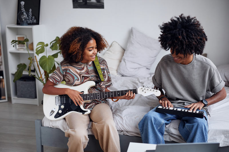 HSC students playing guitar in spare time