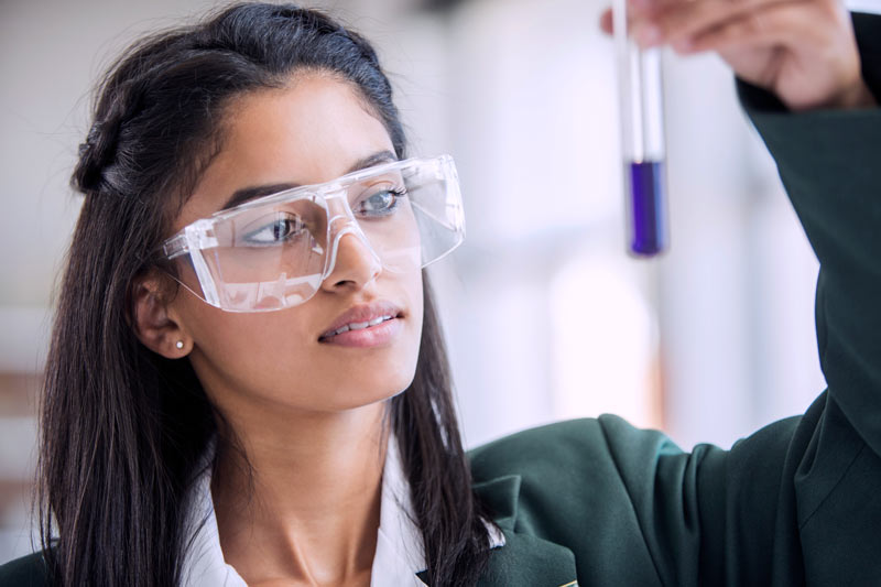 high atar student focusing in chemistry lab to get into her university course