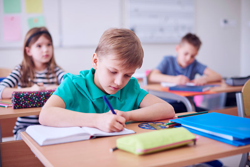 Student using workbook study tips to improve grades