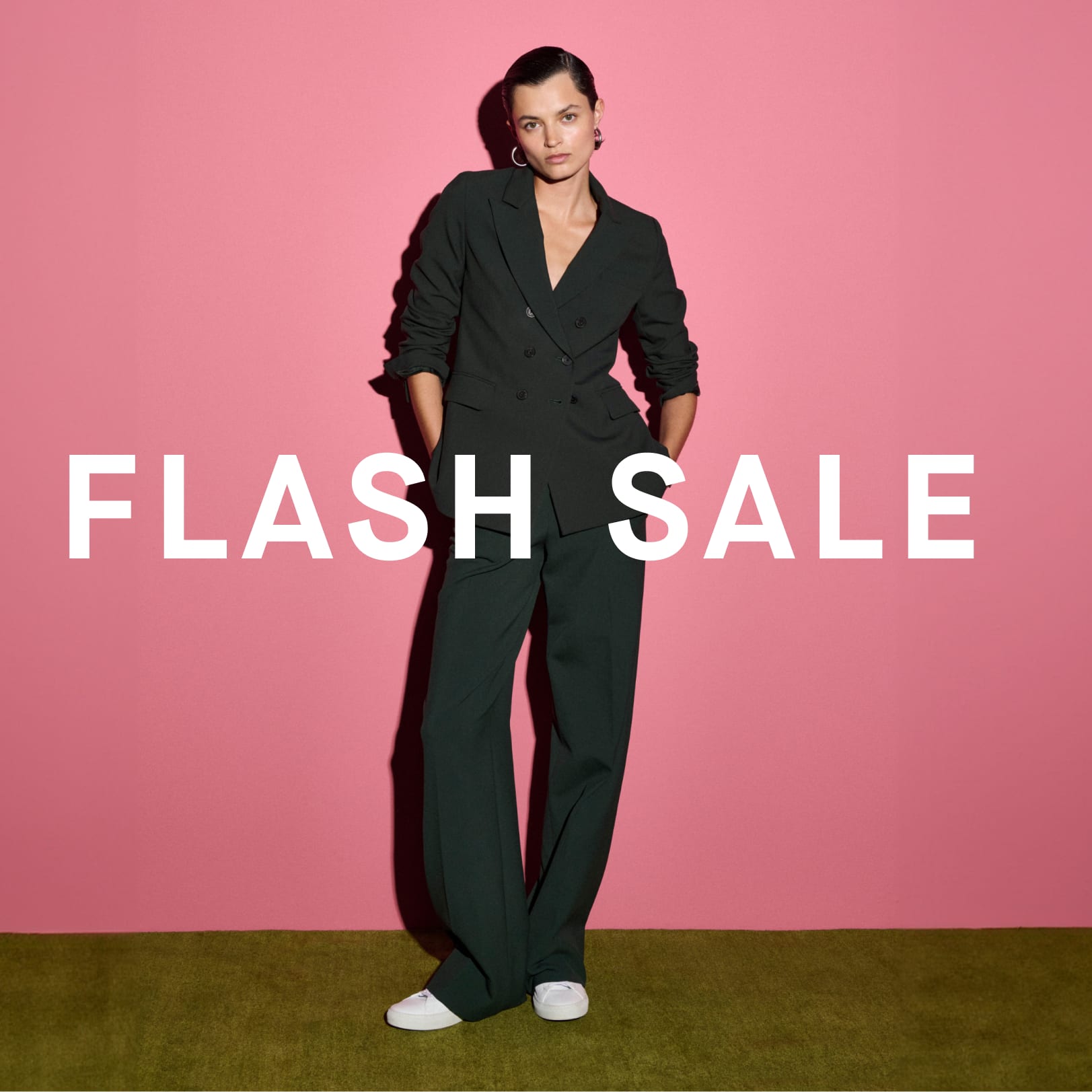 Image of a woman wearing a green suit with the words FLASH SALE