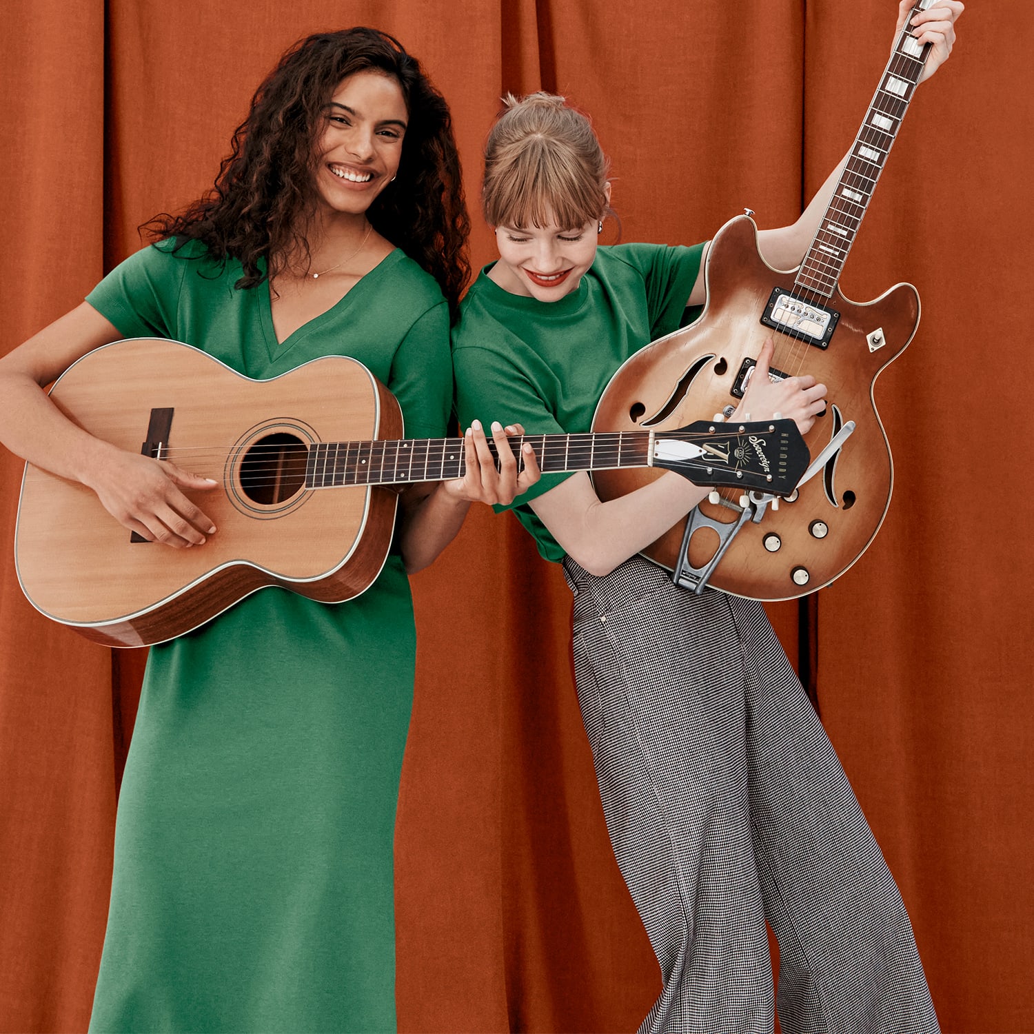 image of two women playing the guitar