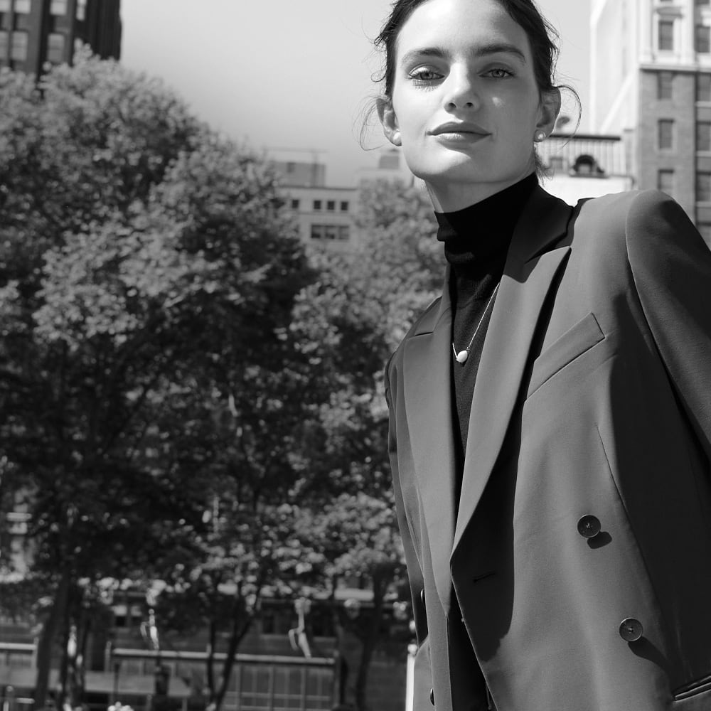 image of a woman wearing the gwynne dress as a blazer in the park