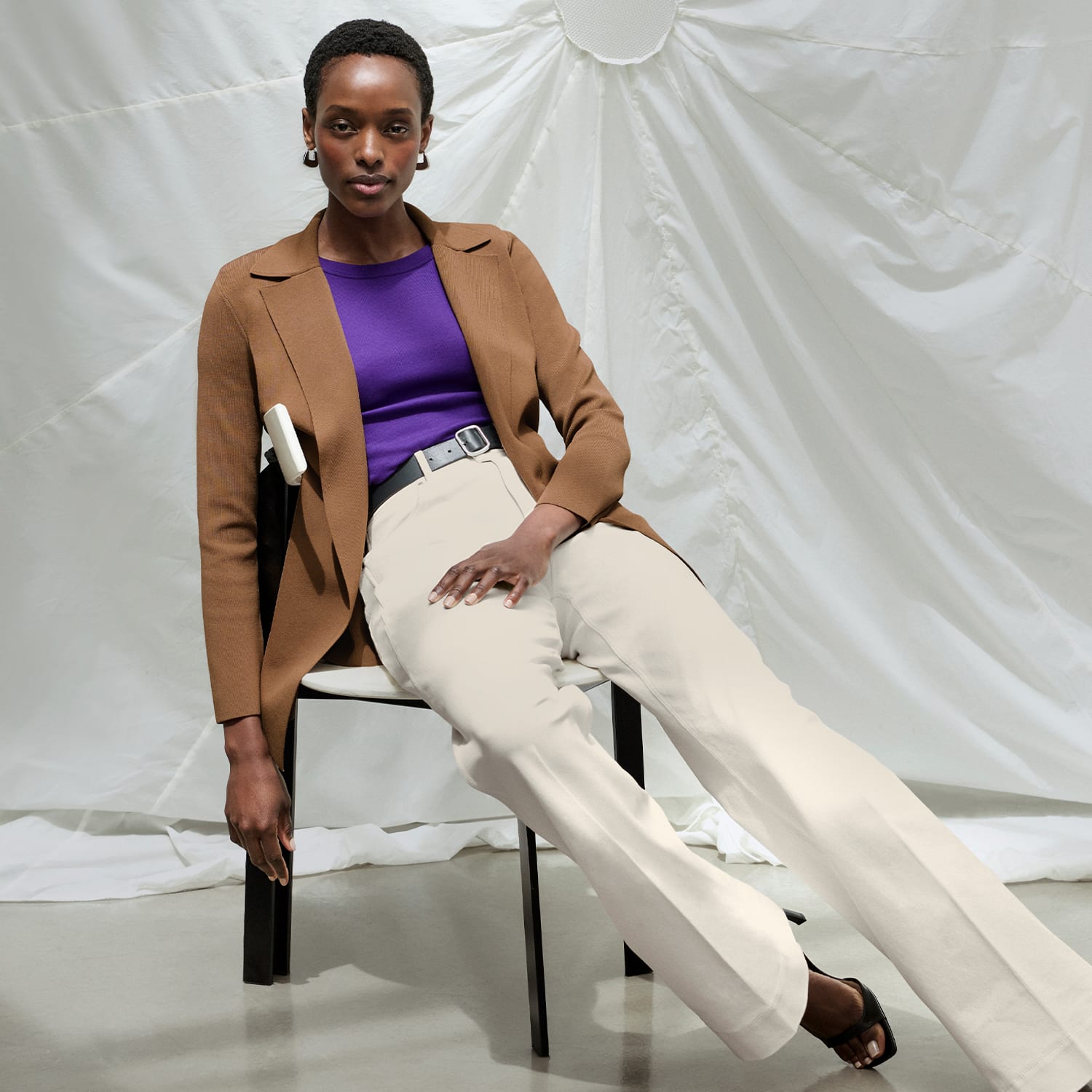 image of a woman wearing the merritt jardigan in saddle with the malley top in ube and milo jean in tusk