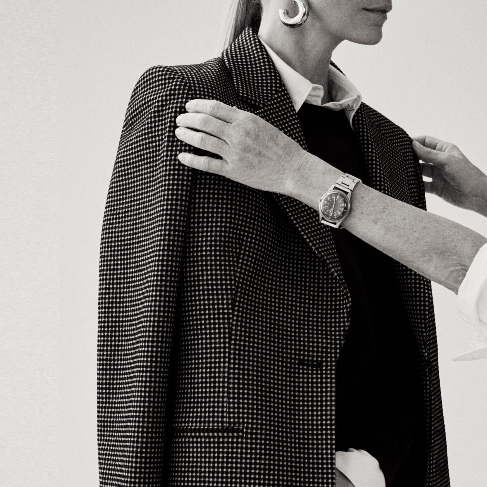 Image of a stylist adjusting a blazer on her client