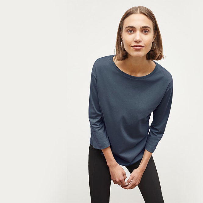 Woman wearing the Lisey cami in sahara print, Foster pant in black and the Anna jacket in black.