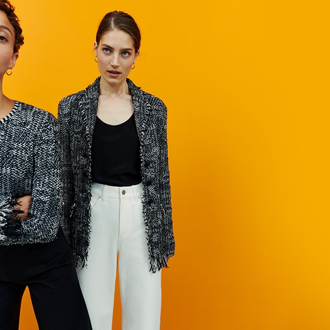 two women wearing black and white outfits