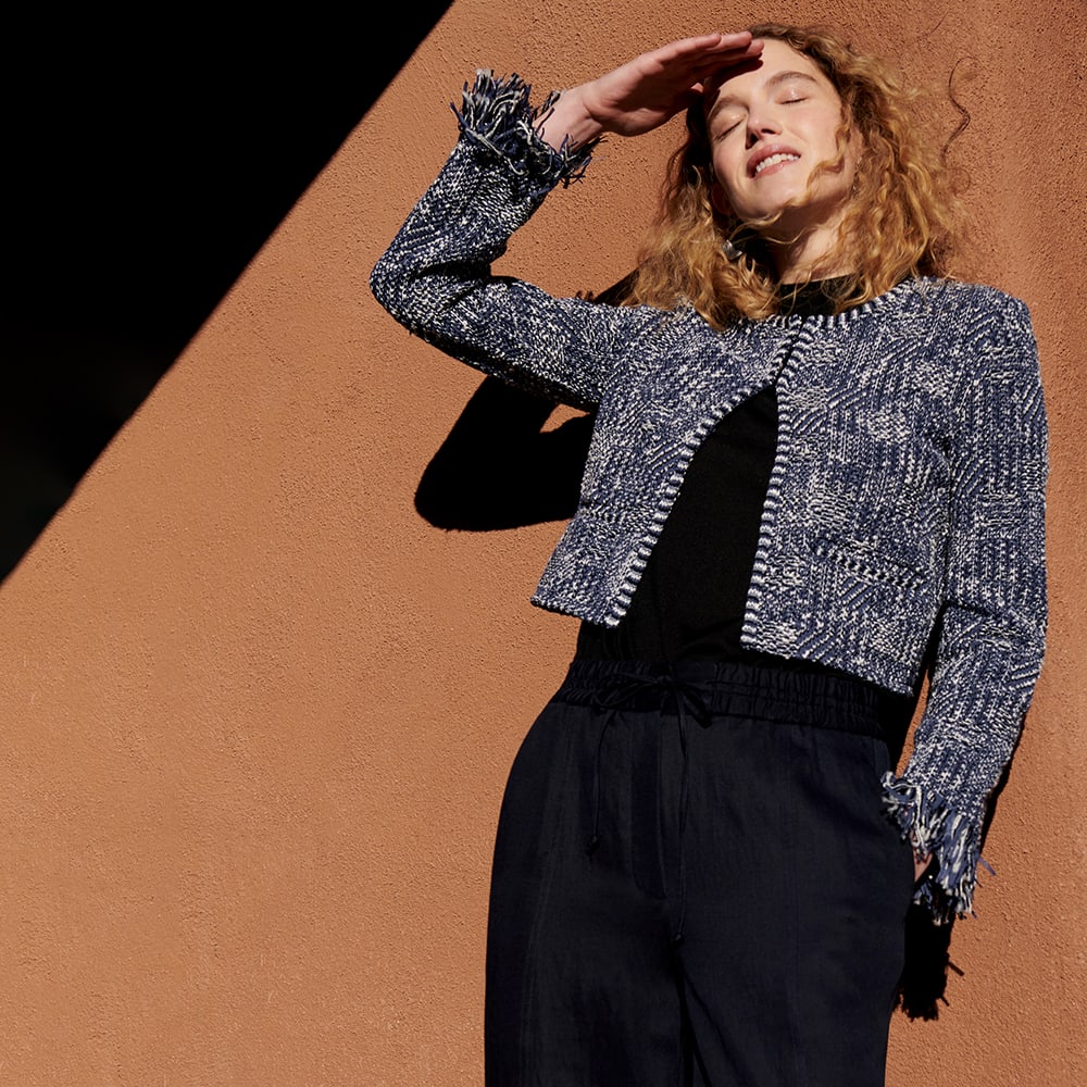 Woman in navy and ivory woven jacket