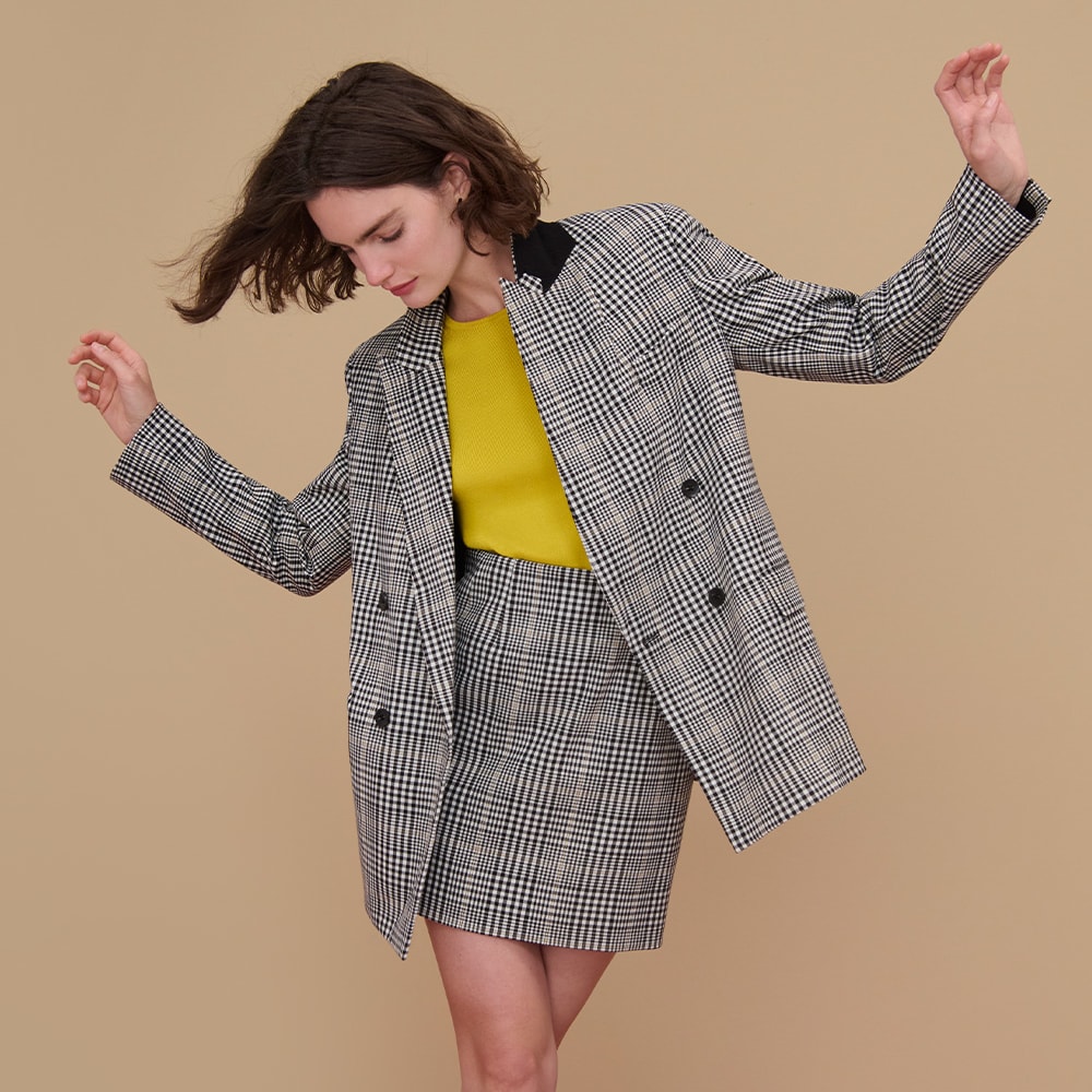 woman standing wearing the o'hara blazer and whitney skirt in plaid sharkskin with the choe top in chartreuse