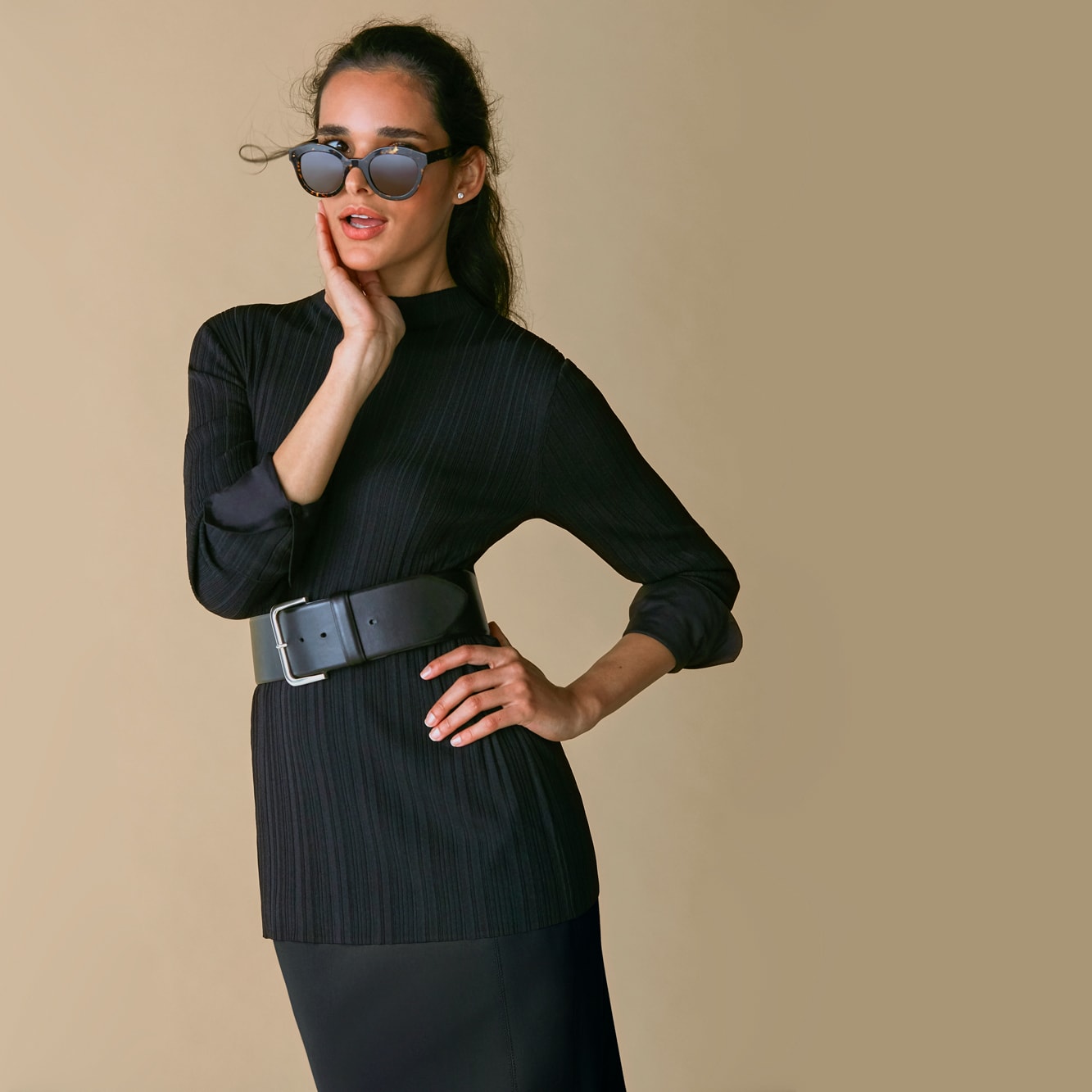 Woman wearing the Emiko top, Beebe belt, and Dorchester skirt