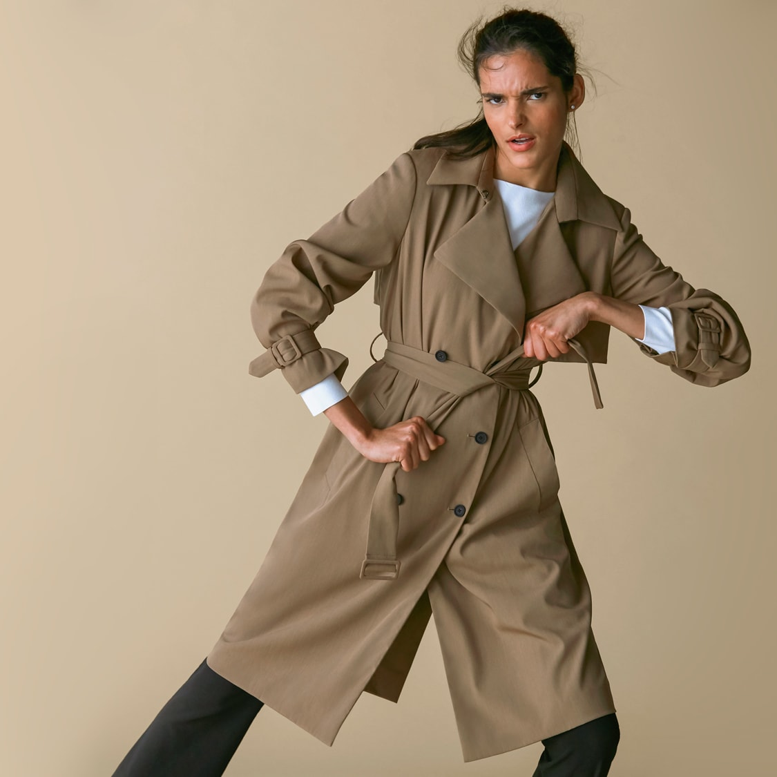 Woman wearing the Jensen trench and the Celeste top