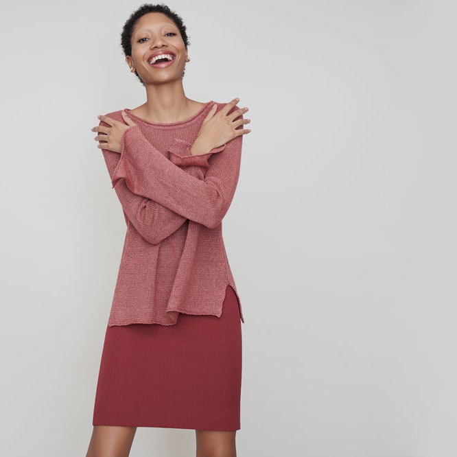 Woman wearing the Samara sweater and the Noho skirt.
