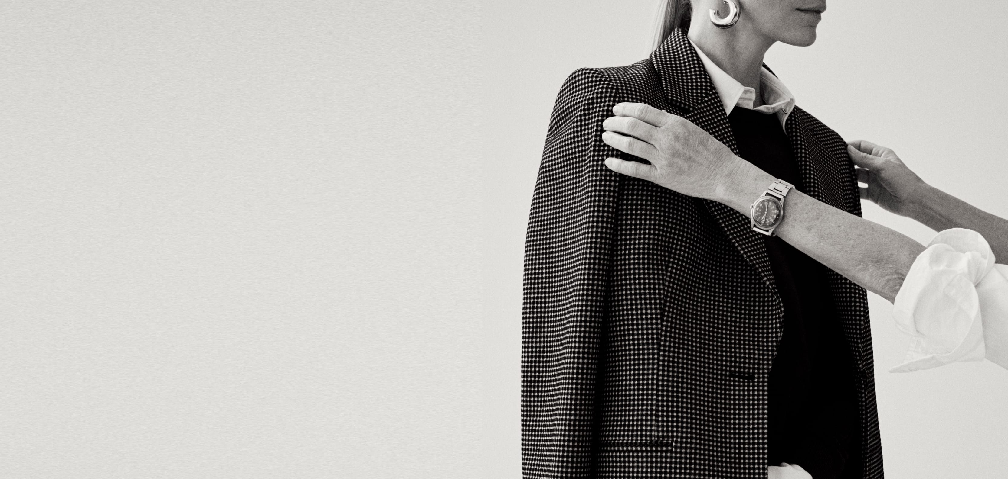 Image of a stylist adjusting a blazer on her client