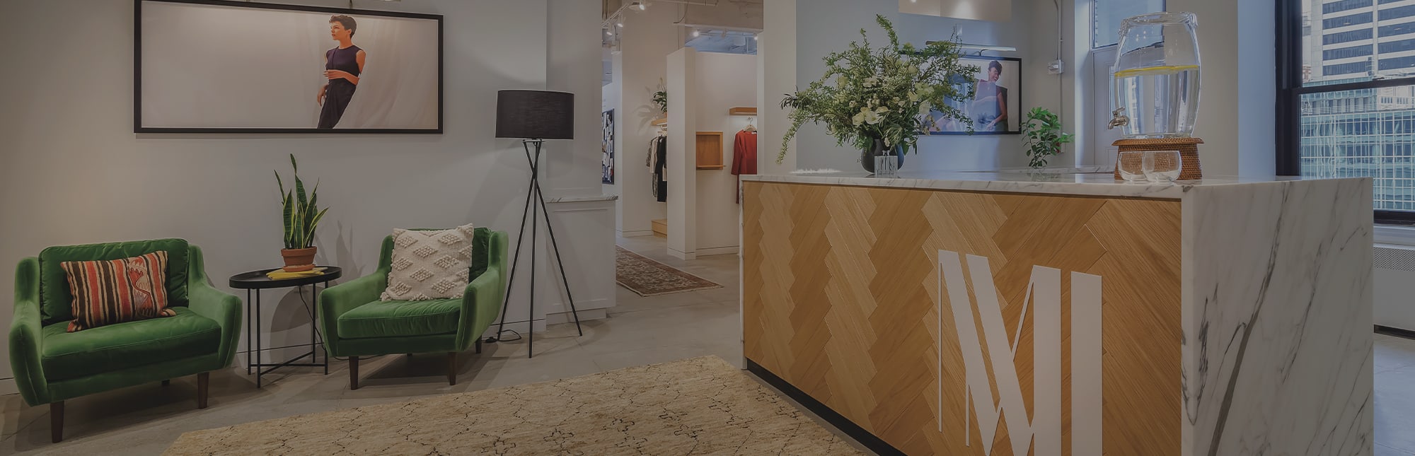 woman standing in nyc wearing the gwynne jacket in olive. 