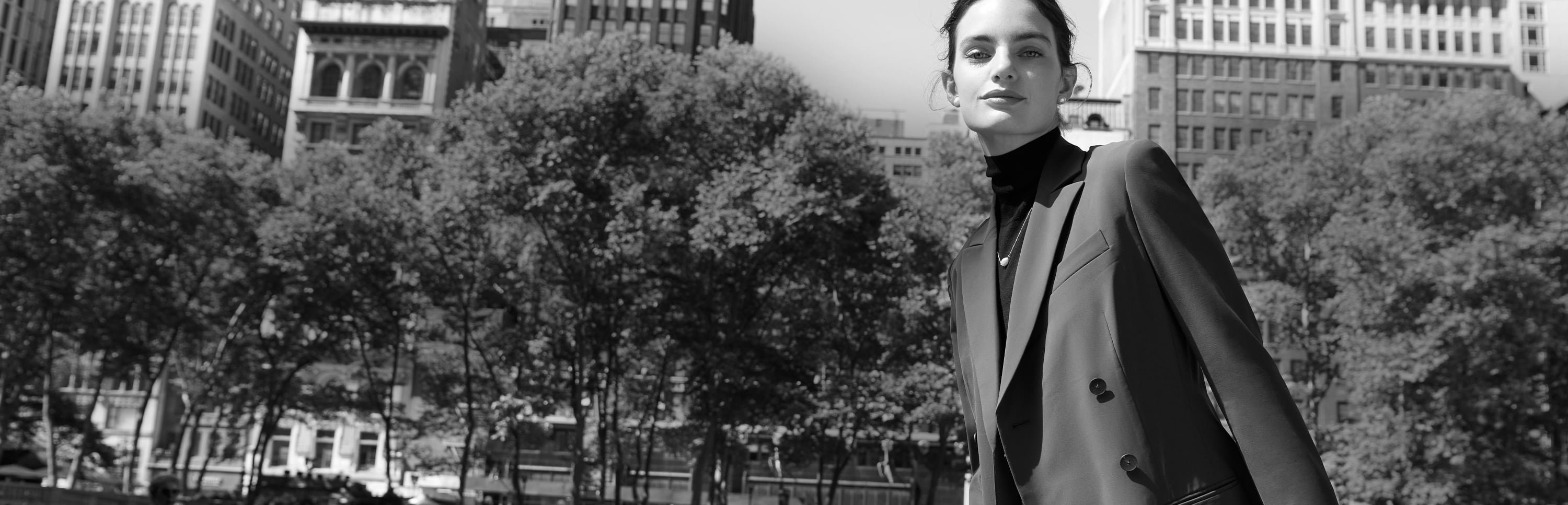 image of a woman wearing the gwynne dress as a blazer in the park