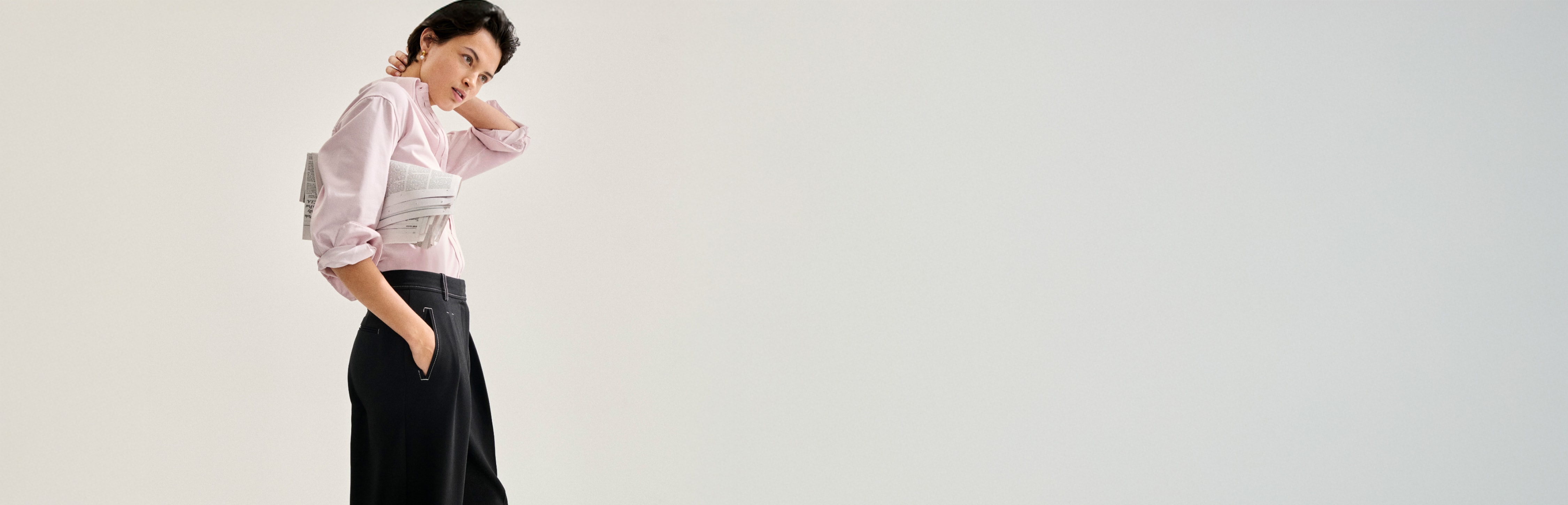 image of a woman holding a newspaper while wearing the filomina top in tulip