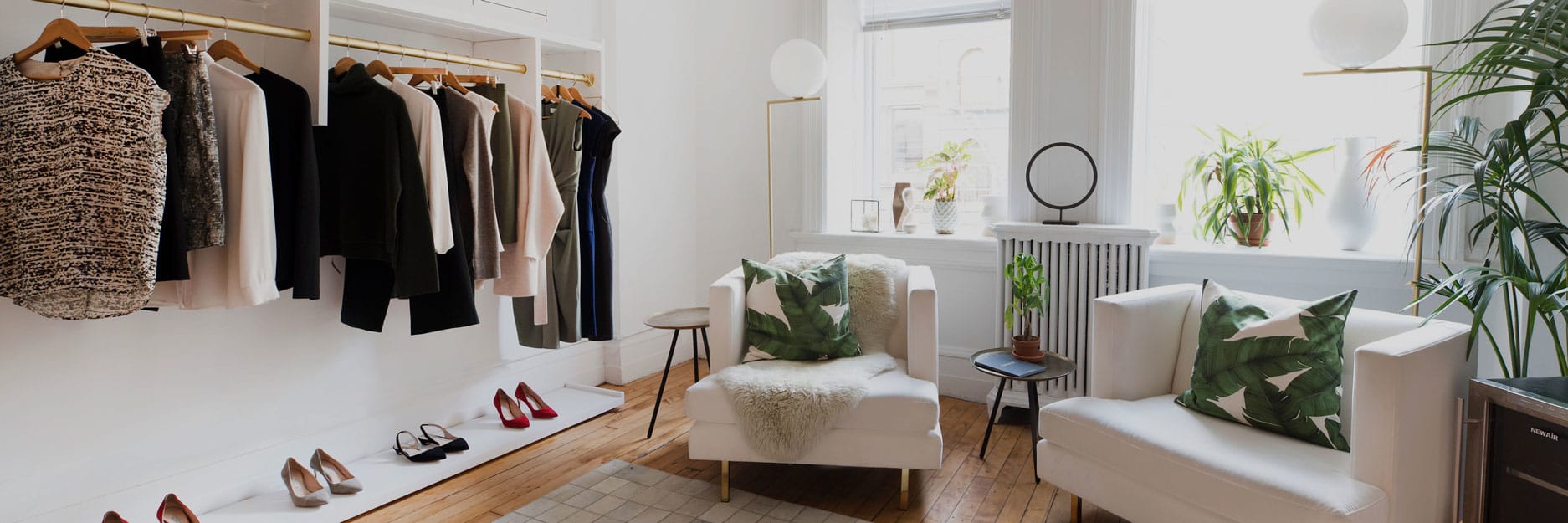 Interior of showroom with chairs and clothing rack