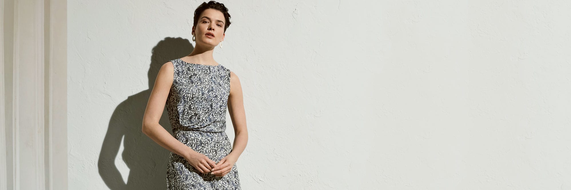 Woman wearing Bergman top and winthrop skirt in ivy print