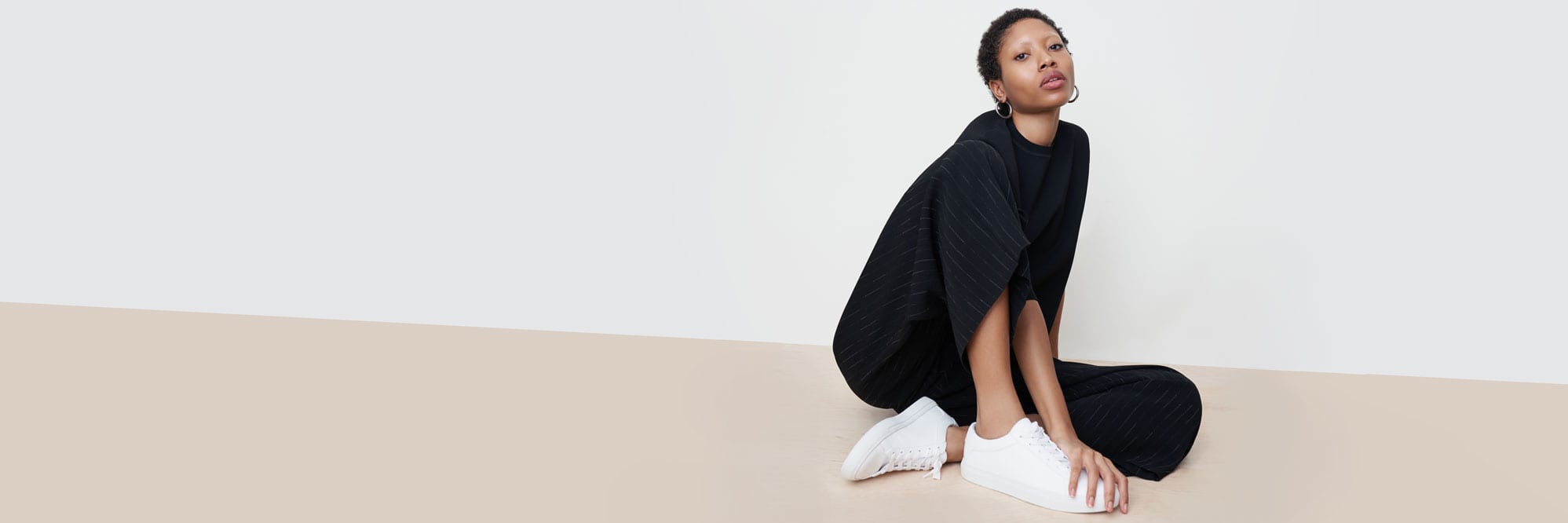 Woman wearing the Zhou culotte, Para pullover, and KOIO sneakers.