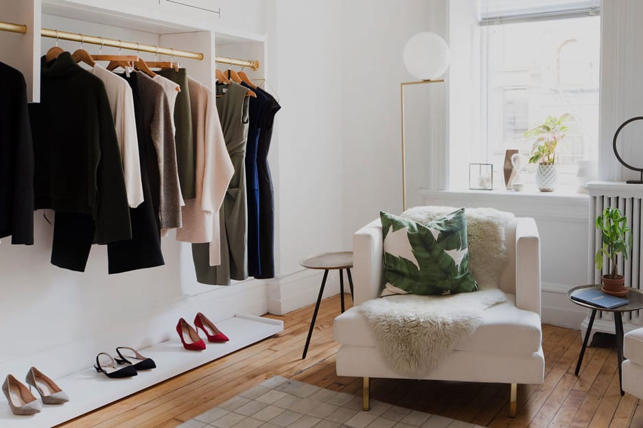 Interior of showroom with chairs and clothing rack