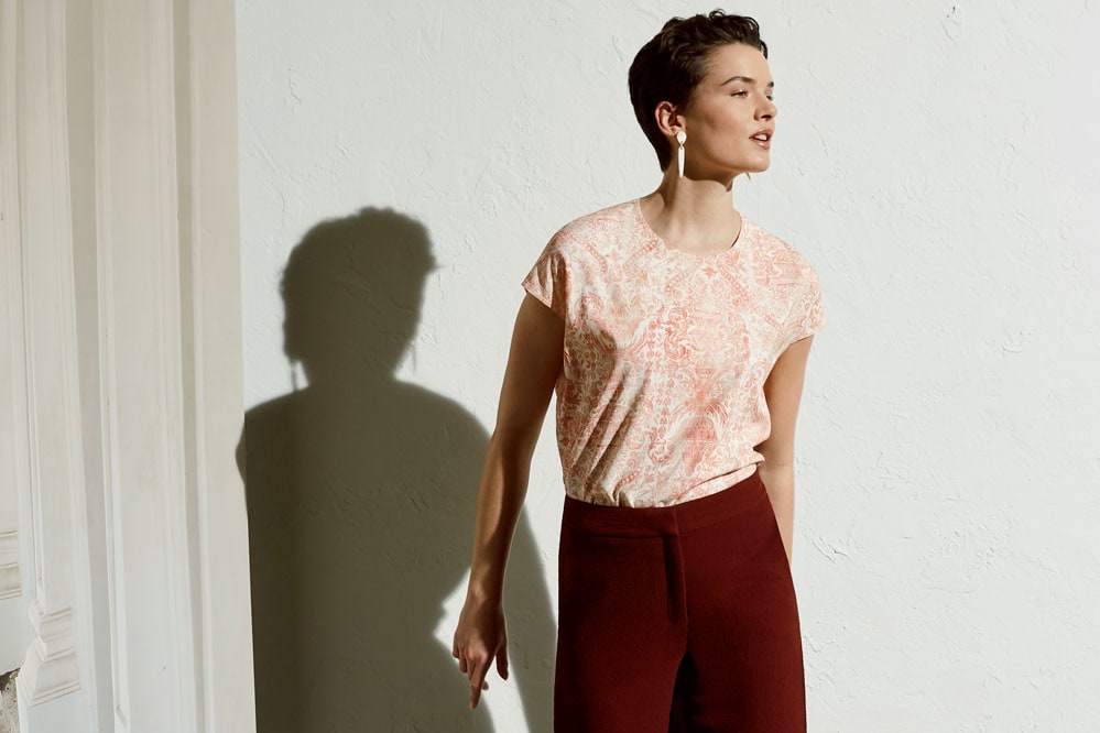 Woman wearing Didion top in Baroque print
