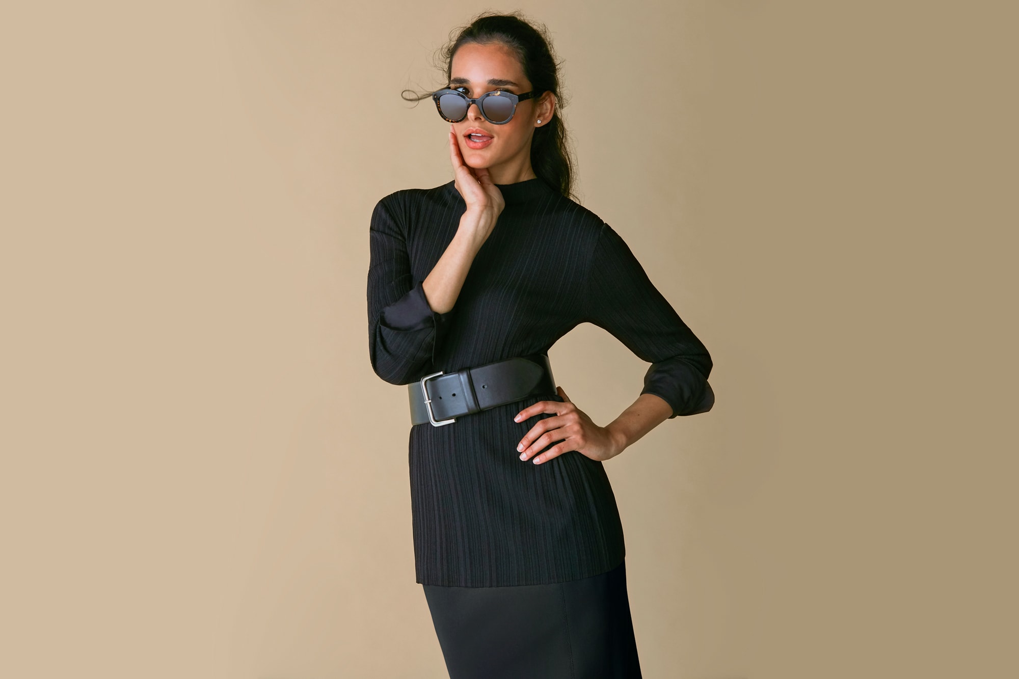 Woman wearing the Emiko top, Beebe belt, and Dorchester skirt