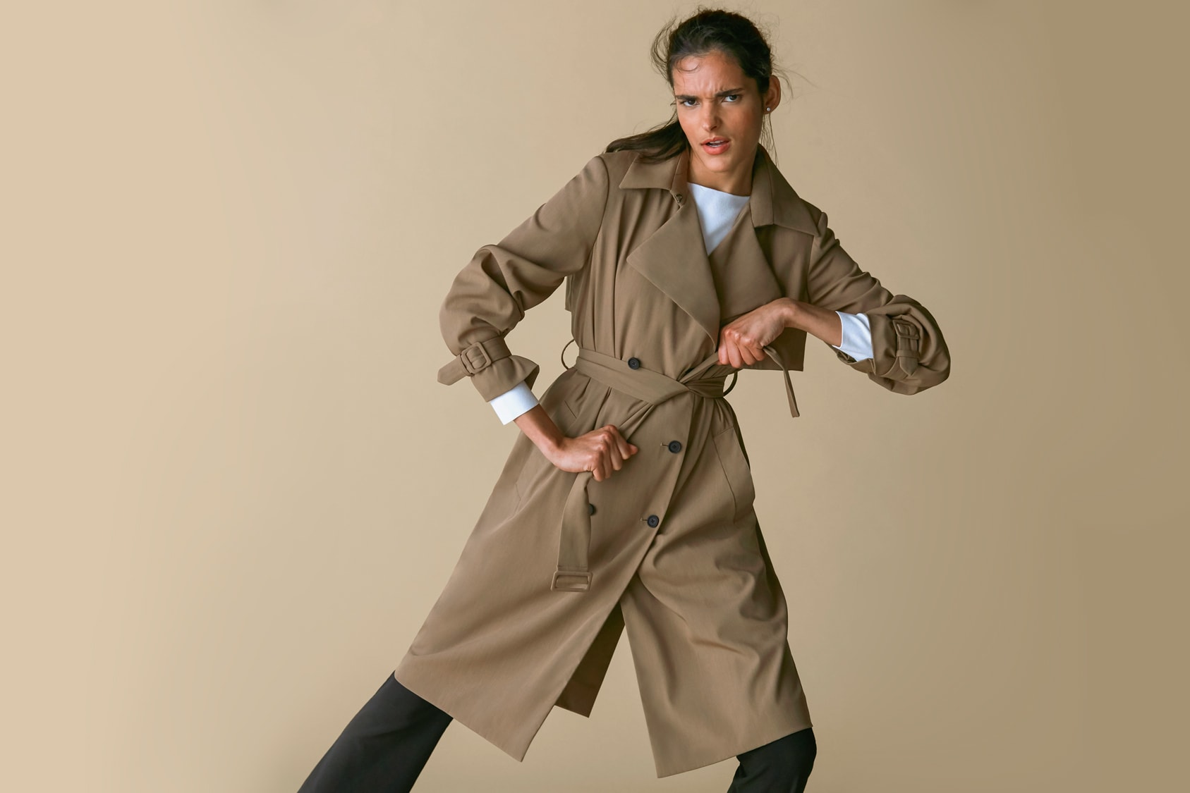 Woman wearing the Jensen trench and the Celeste top