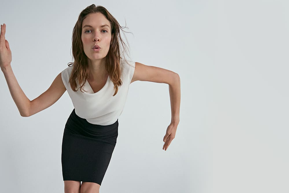 Woman wearing the Rowling top and Noho skirt