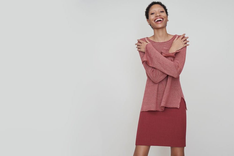 Woman wearing the Samara sweater and the Noho skirt.