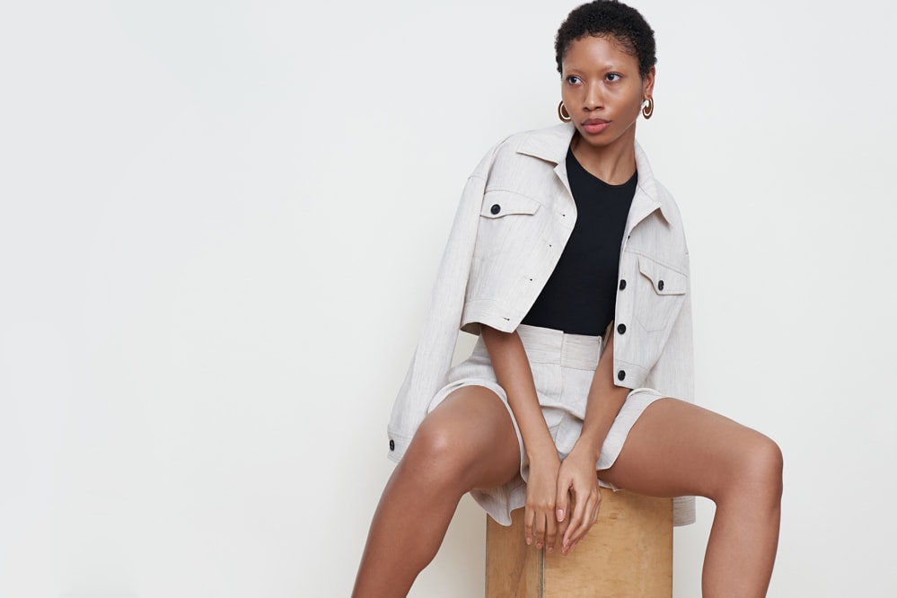 Woman wearing the Anna Jacket, Paige top, and Caitlin shorts.