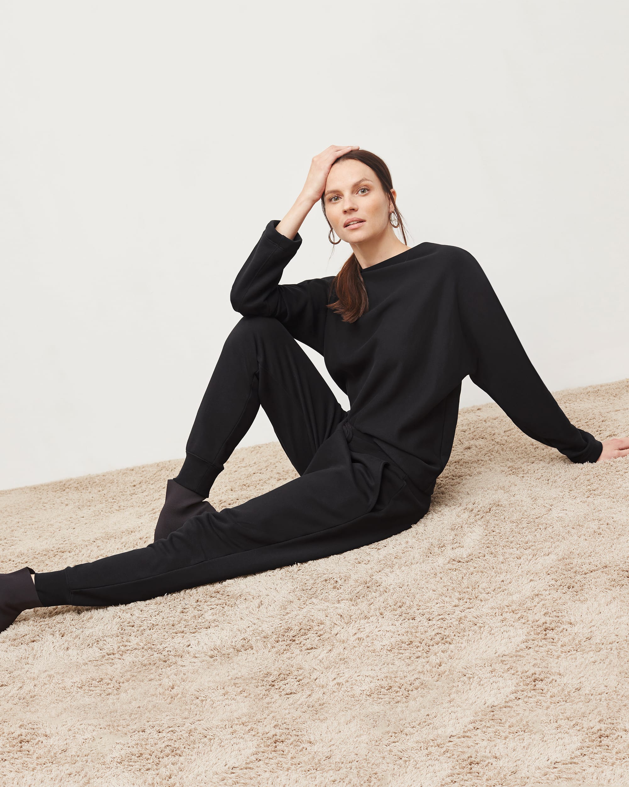 Woman in black top and joggers