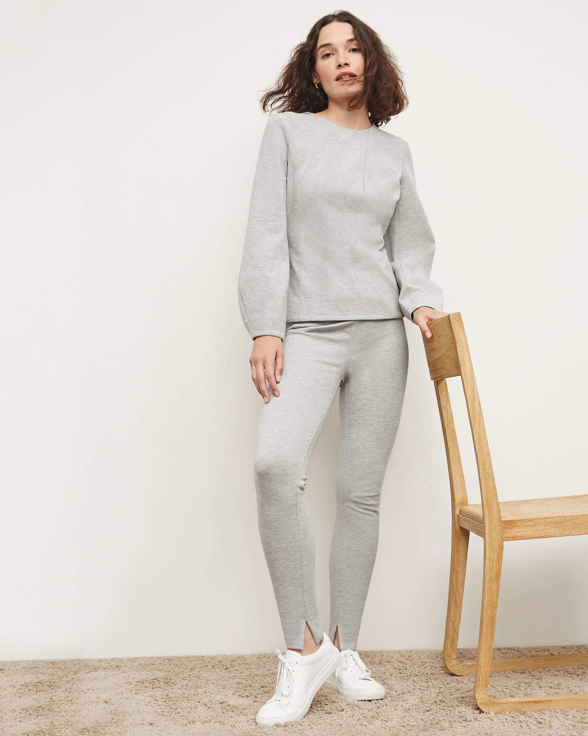 Woman in long-sleeve gray melange top and leggings