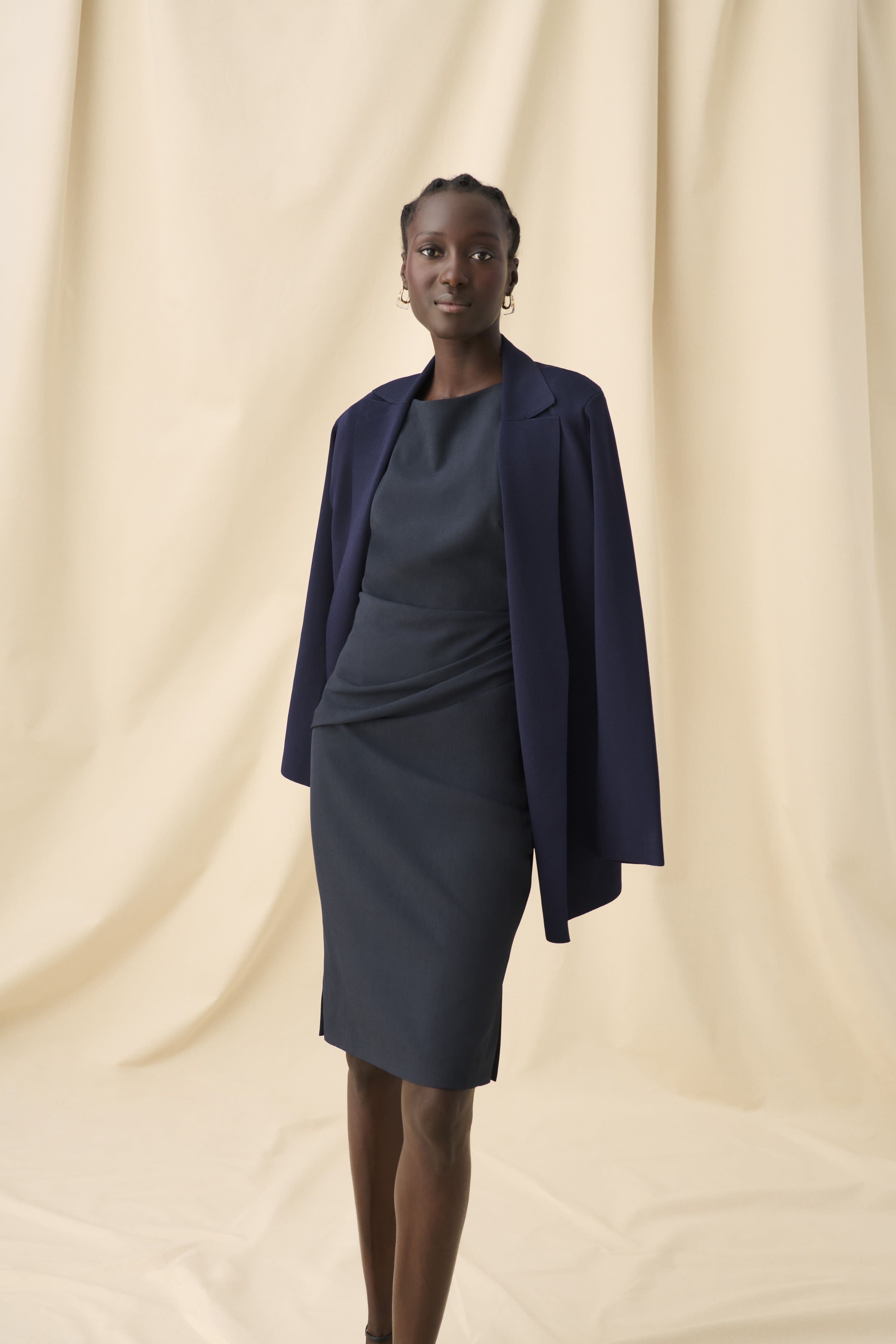 image of a woman wearing the merritt jardigan in navy and maisie dress in midnight