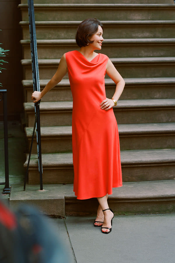 image of sarah lafleur wearing the priya dress in bright coral