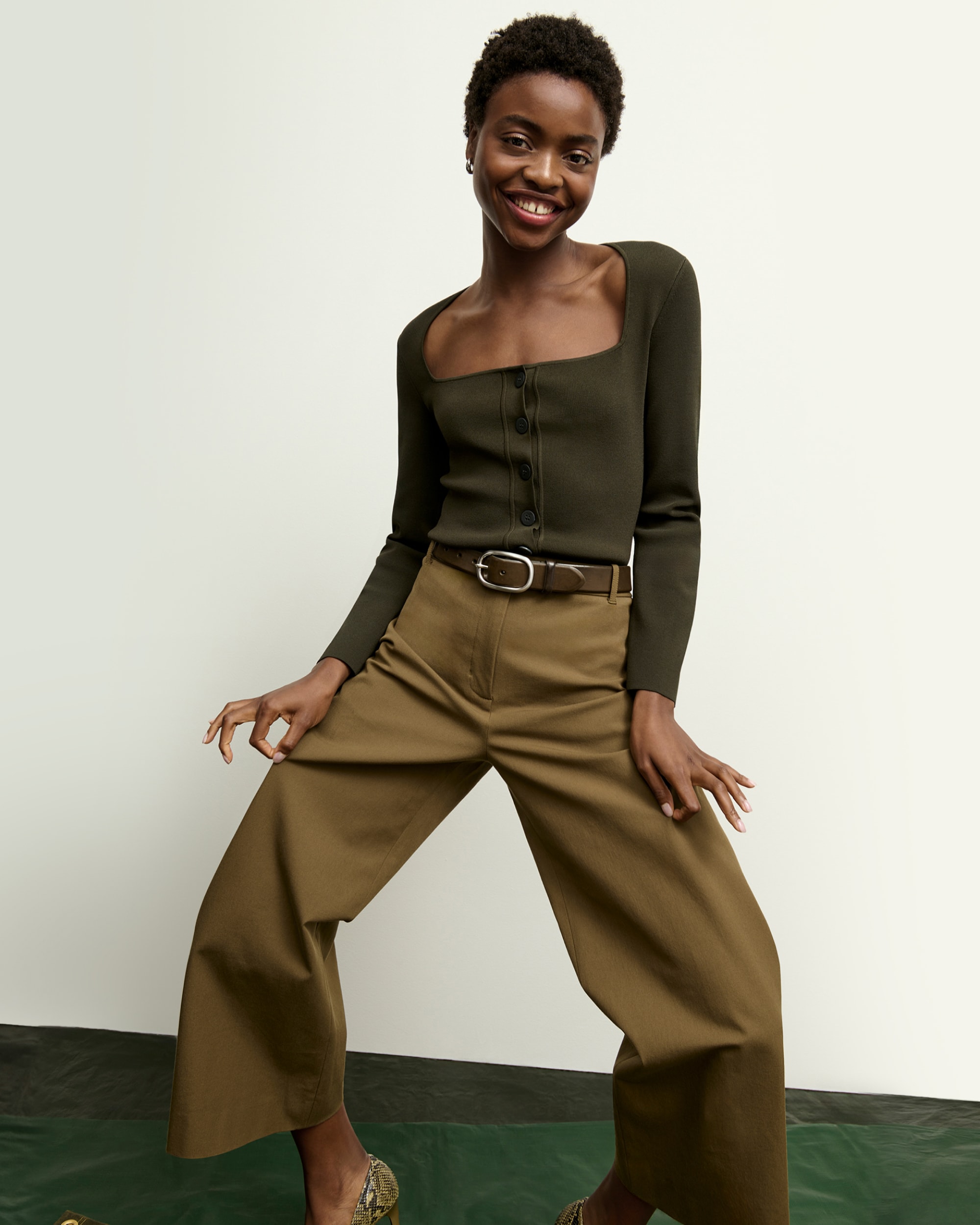 front image of a woman wearing the jin jardigan in dark elm and the abby pants in oregano