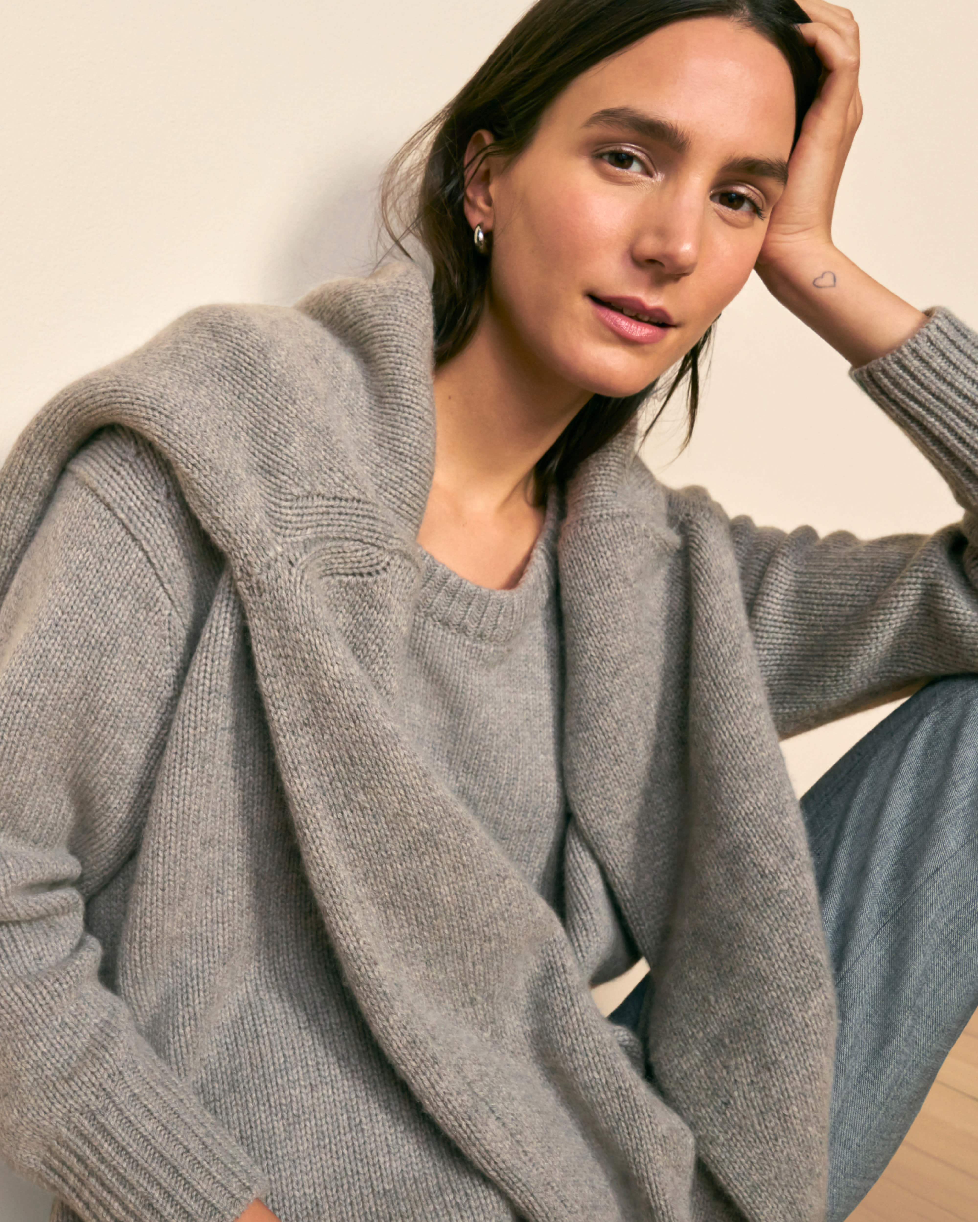 front image of a woman wearing the theo sweater with the lea sweater layered and the tinsley trousers