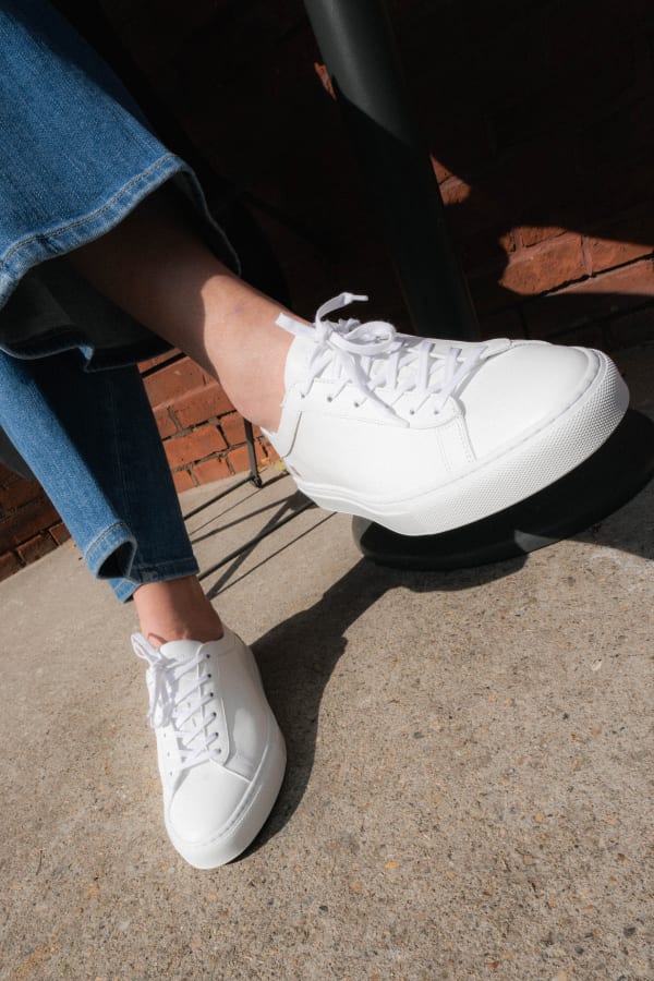 close up image of the koio sneakers in white