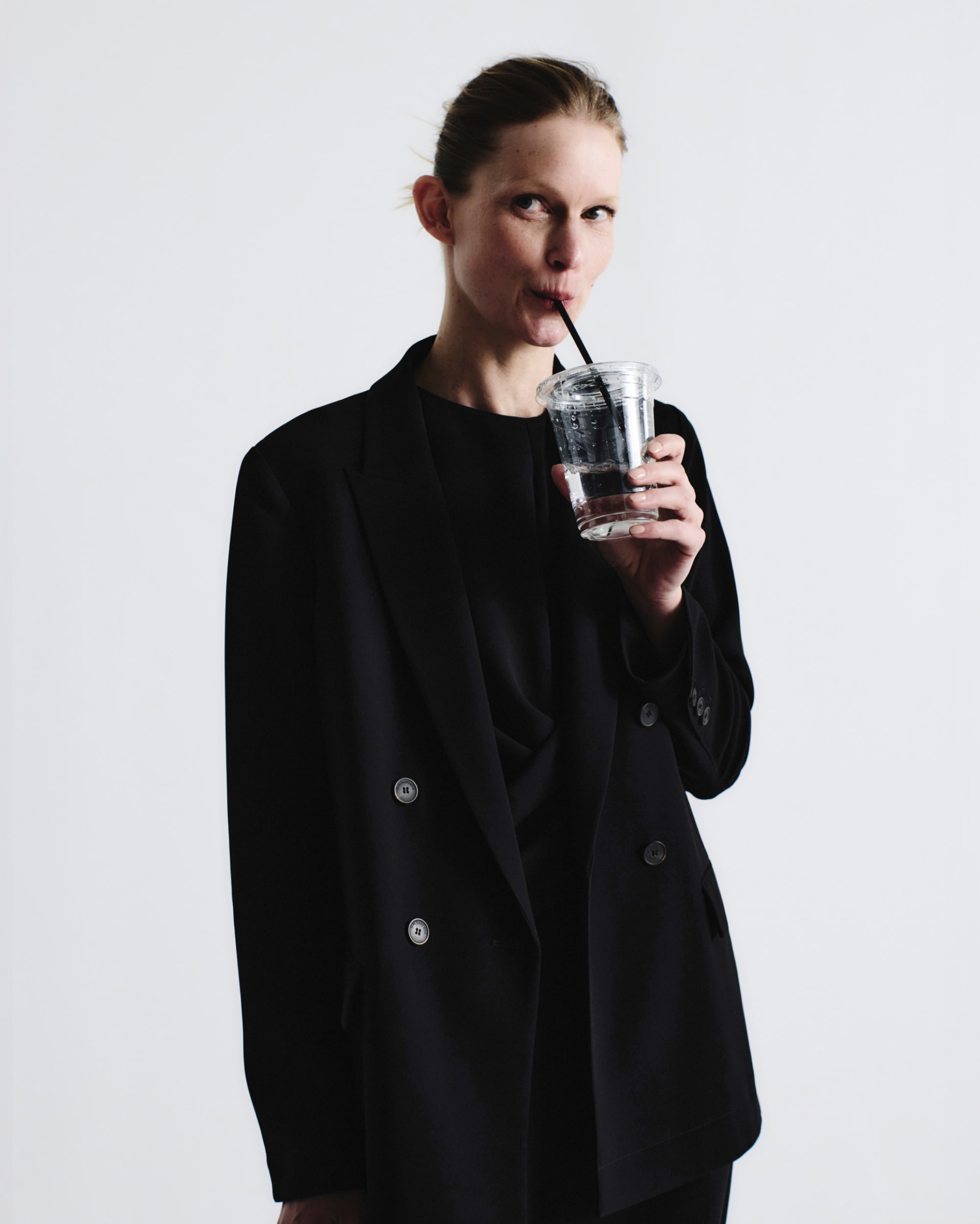 image of a woman wearing the luz dress in black with the ohara blazer in black