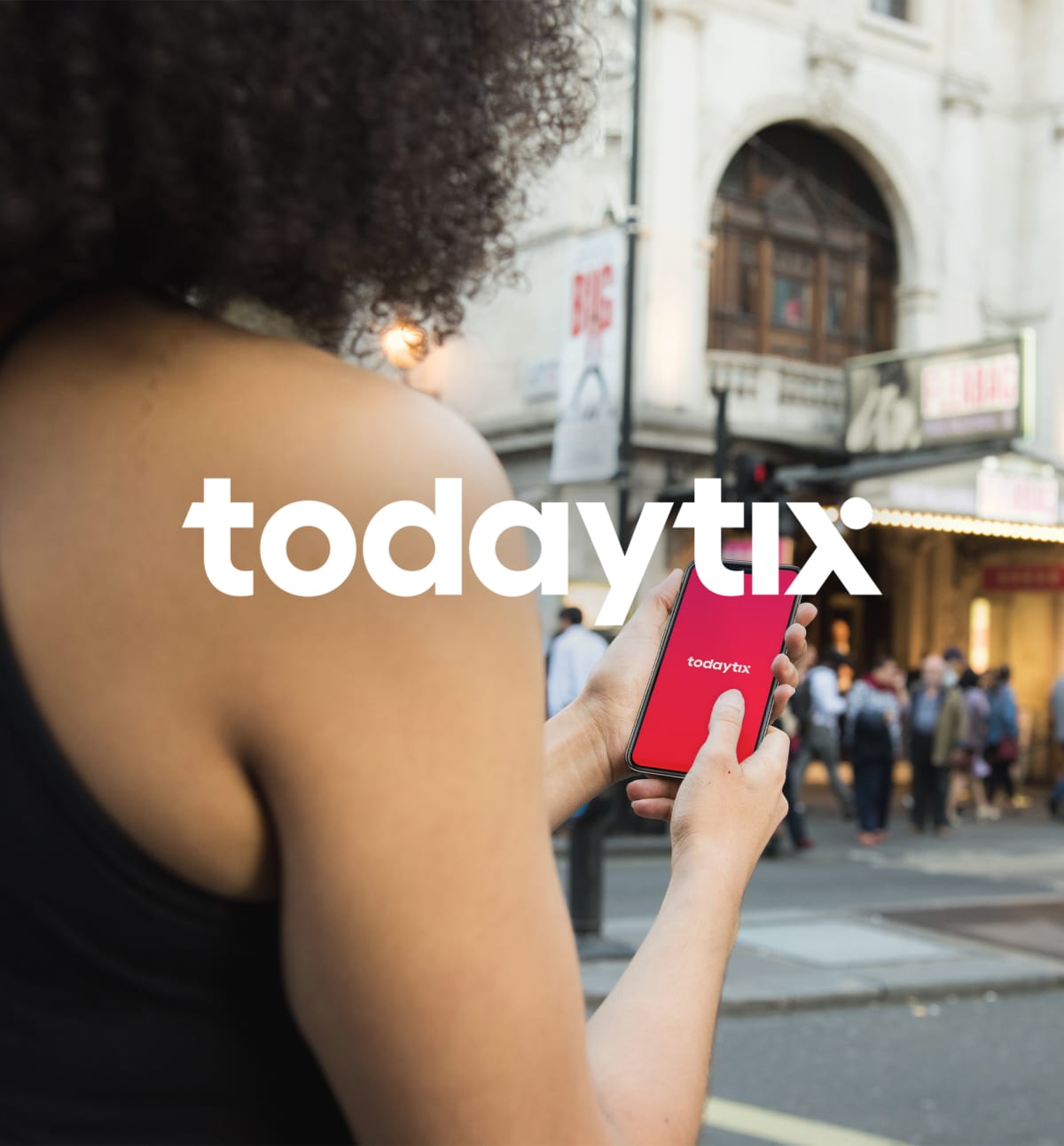 TodayTix logo + woman holding her phone with TodayTix in front of a theater