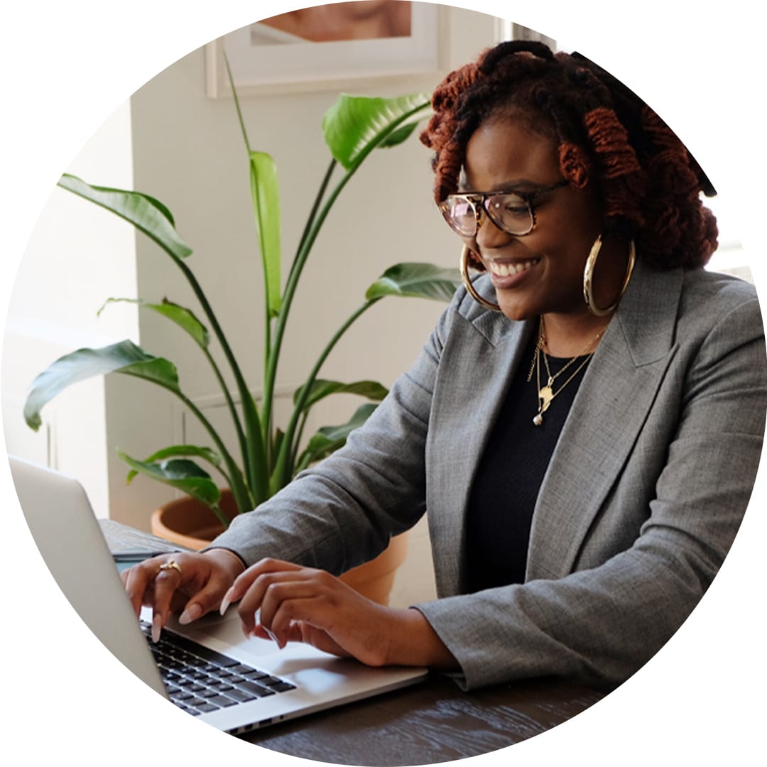 woman smiling and using laptop