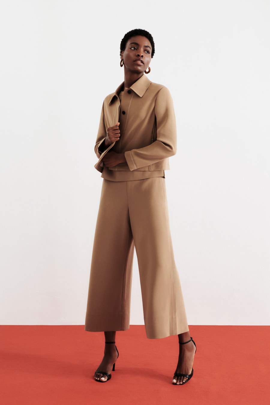 image of a woman wearing the elena pant and nicky jacket in light saddle