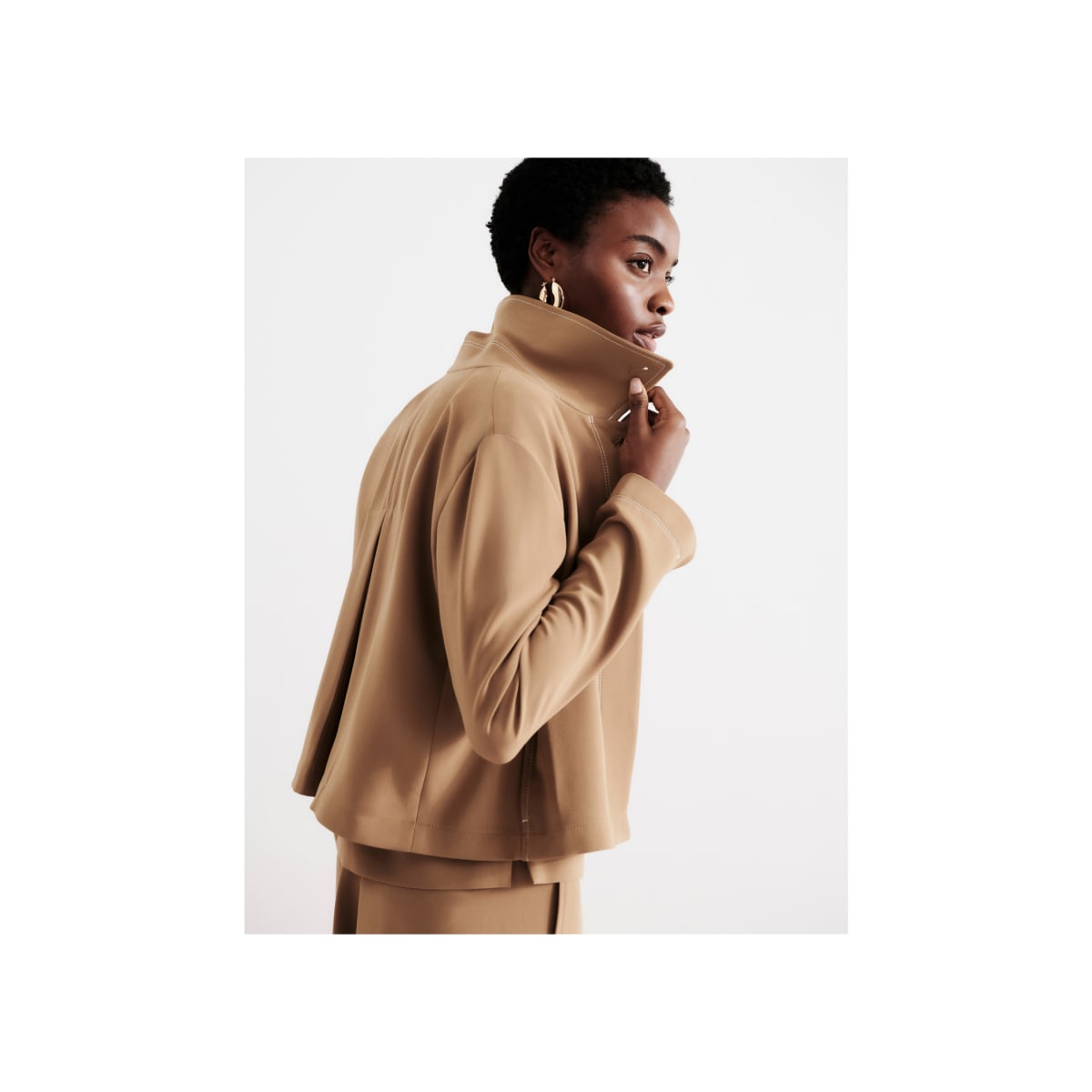 woman wearing light saddle Nicky jacket, popping her collar