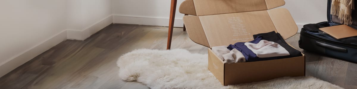 M.M.LaFleur package open with clothes inside on floor