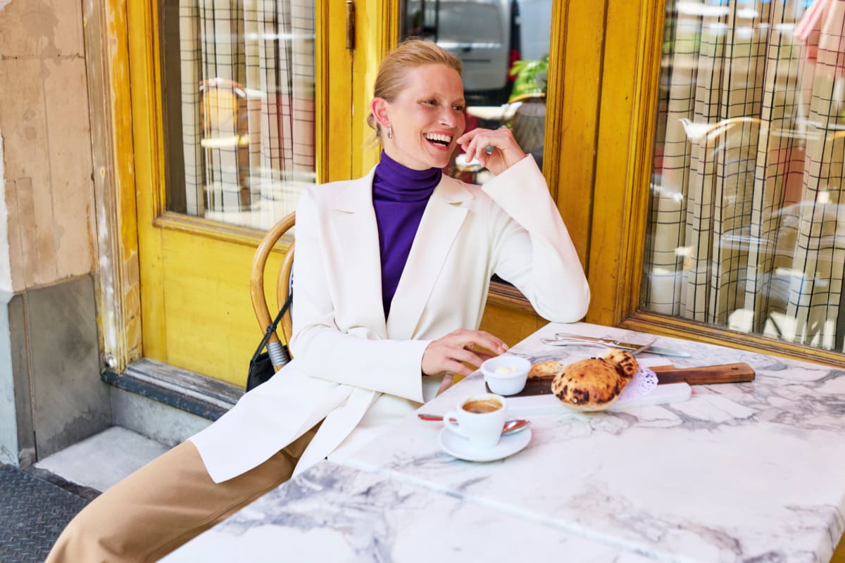 Woman having coffee and treat at cafe